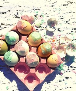 confetti eggs, some cracked, some in a pink egg holder