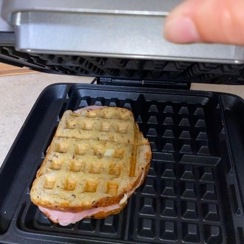 checking to see if sandwich is done in waffle maker