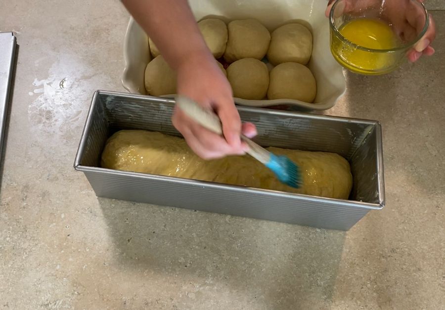 Buttering dough inside a poullman loaf pan