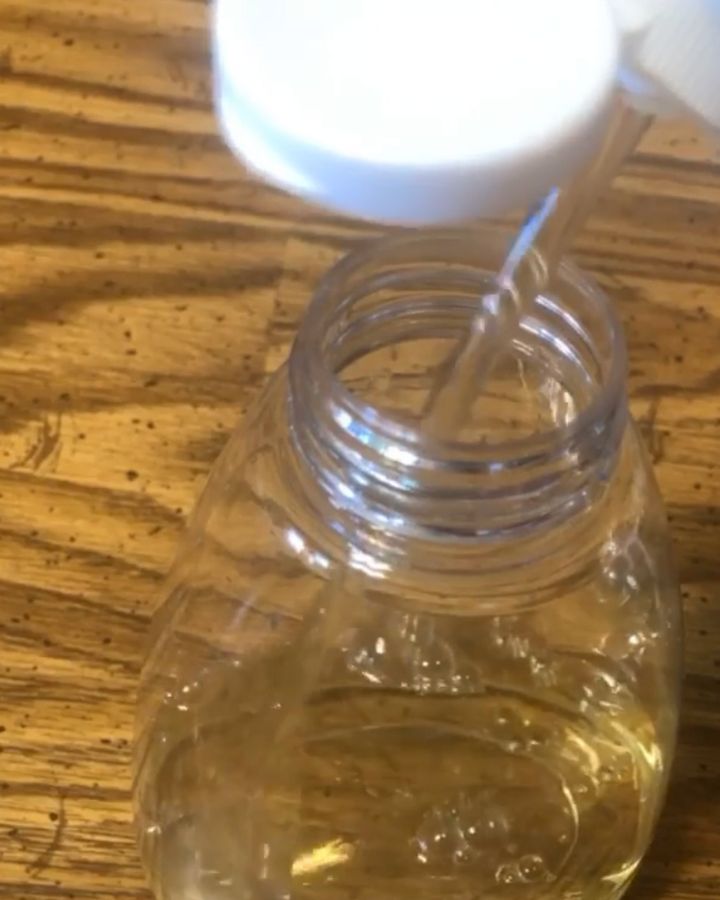 pouring castile soap into soap bottle