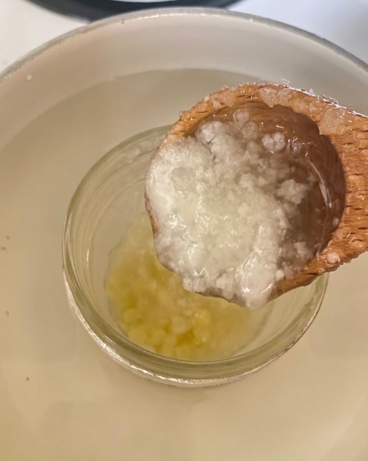 putting coconut oil into jar in a double boiler