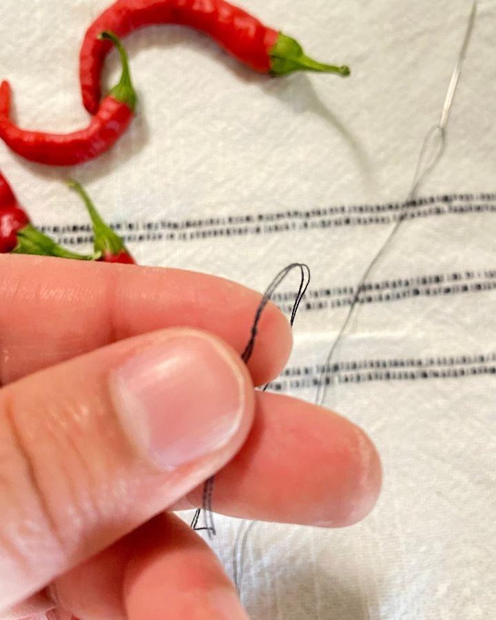 tying a knot for a needle