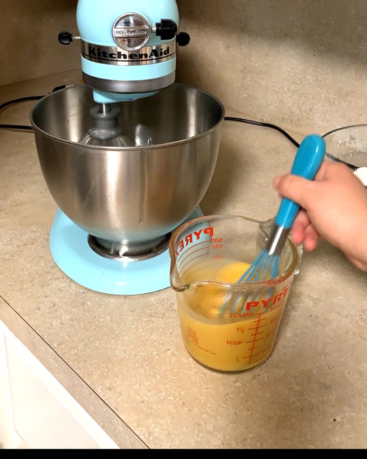 mixing milk,egg yolks,and vanilla with a whisk.