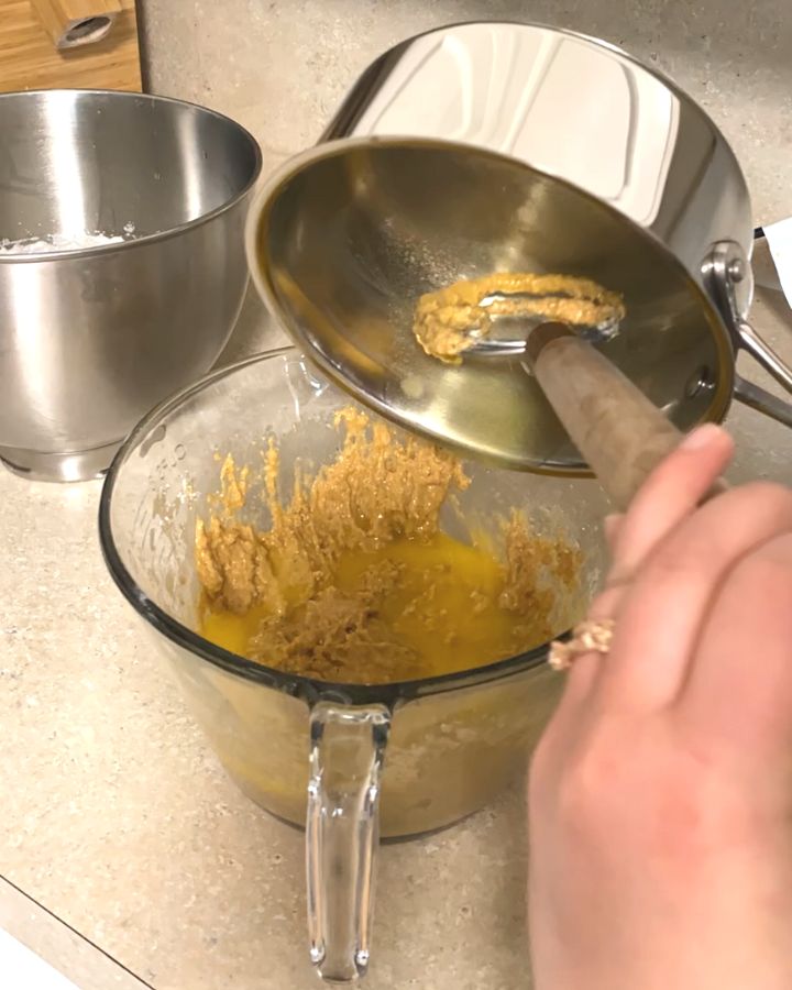 pouring melted butter into batter.